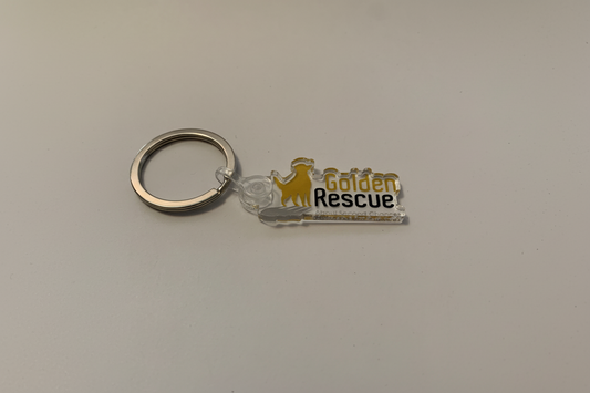 Keychain with 'Golden Rescue' logo on a plain background